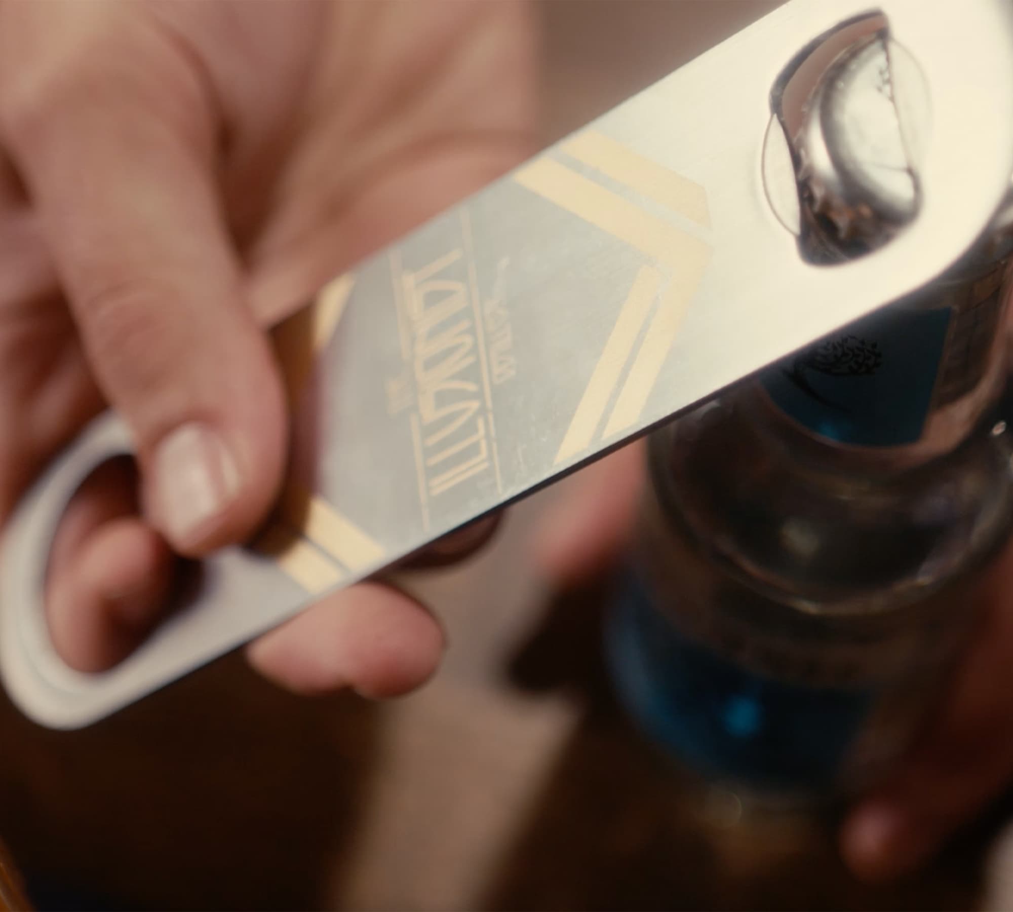 Using the Illusionist Gin bottle opener.